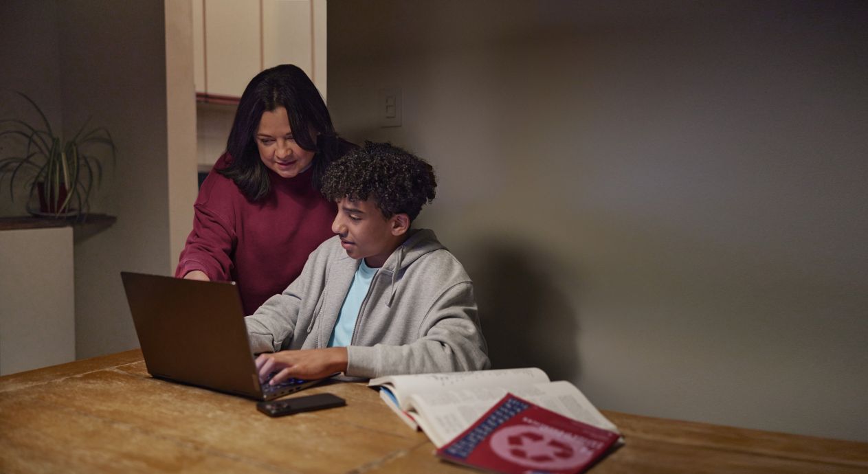 A young person using AI for mental health support with the help of a caring adult