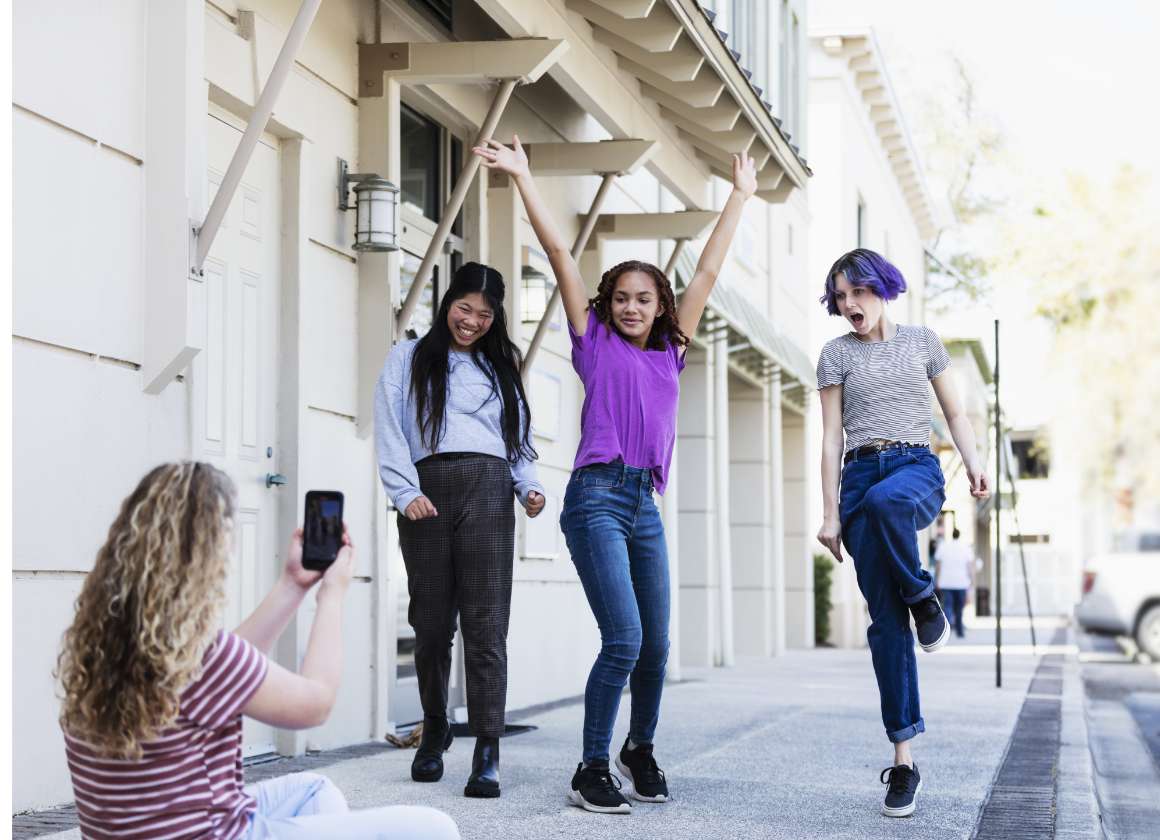 An image on a web page about Kids Help Phone’s mental health website of a group of young people posing and filming on the sidewalk