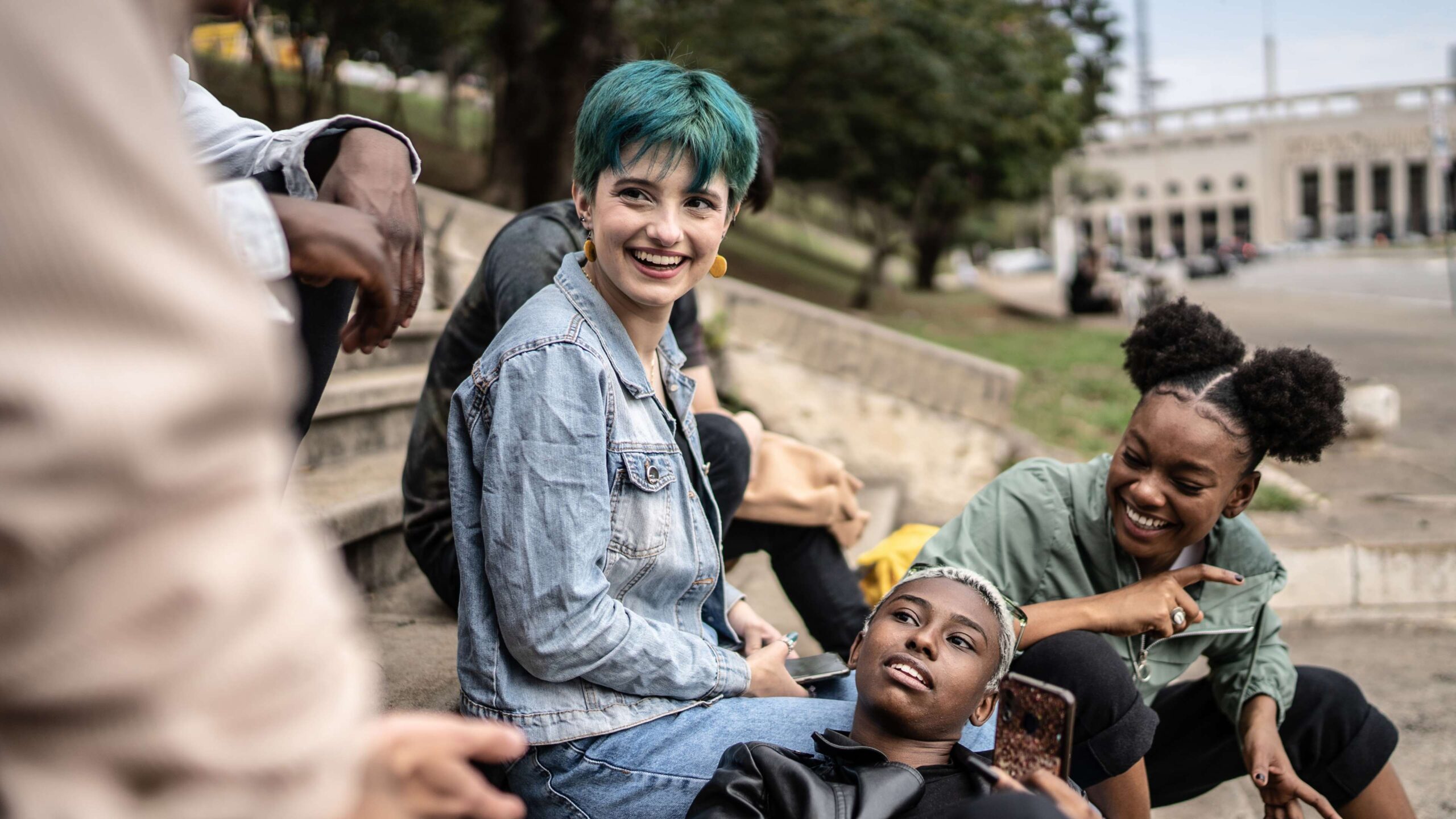 An image on a web page about Kids Help Phone’s mental health website of a group of young people sitting on stairs outside