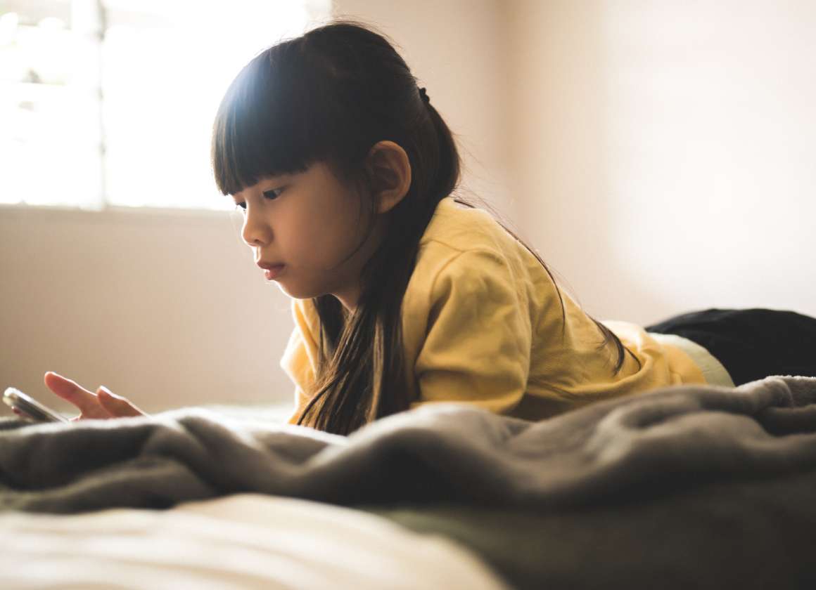 An image on a web page about Kids Help Phone’s mental health website of a young person looking at a phone