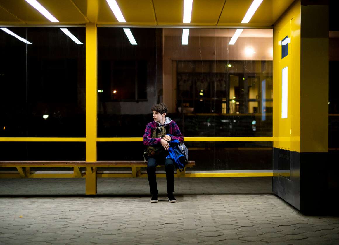 An image on a web page about Kids Help Phone’s mental health website of a young person sitting on a bench