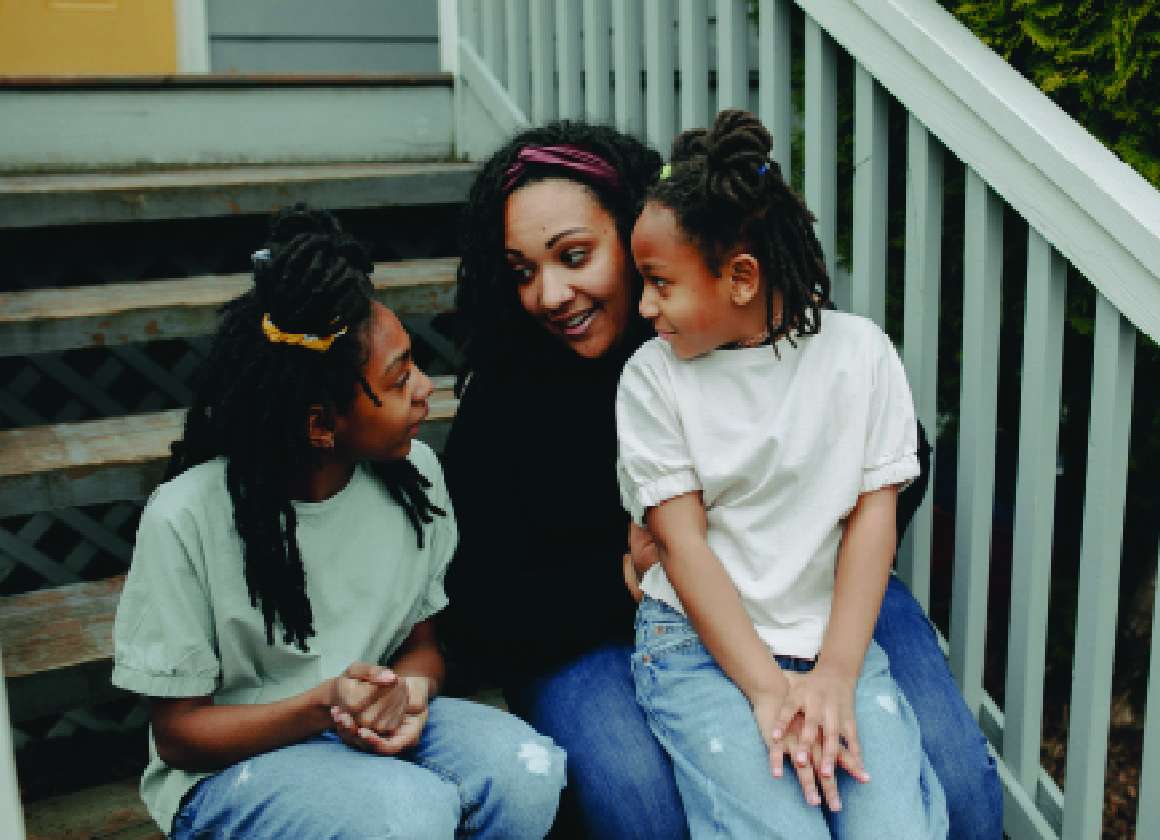 An image on a web page about Kids Help Phone’s mental health website of three people talking on a staircase