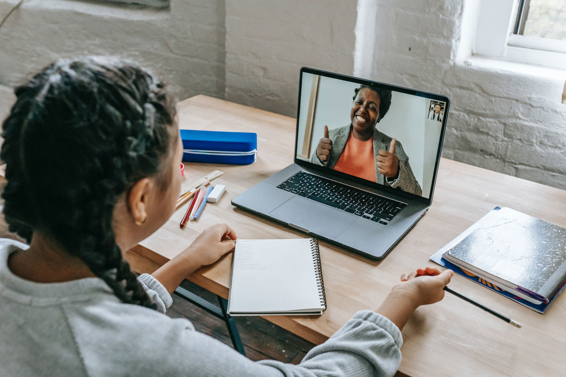 A young person on a video call at a desk