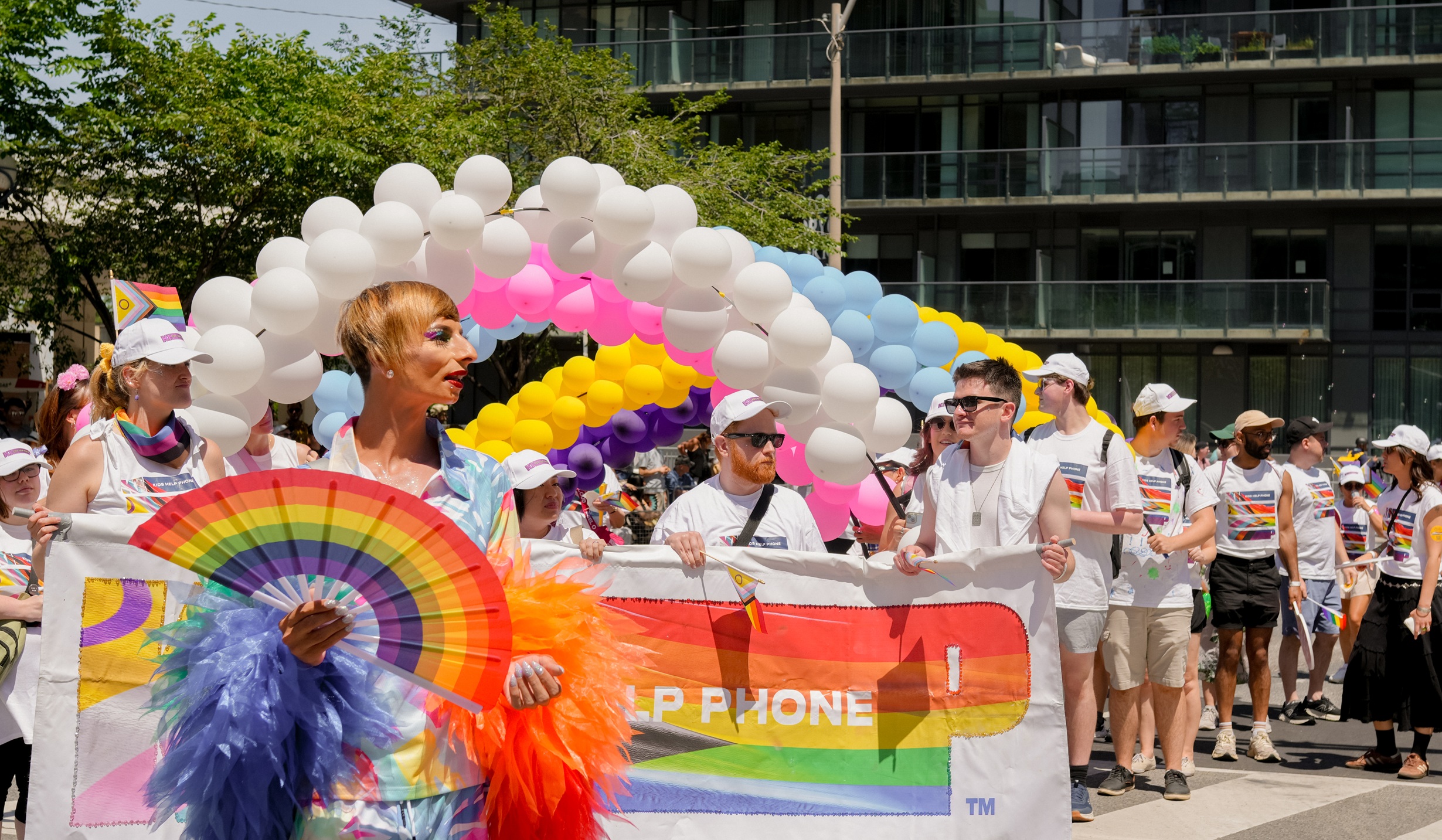 Kids Help Phone staff walking in a Pride parade