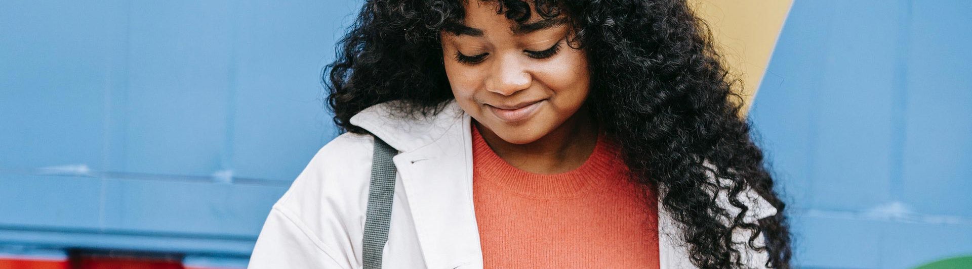 smiling woman looking at phone