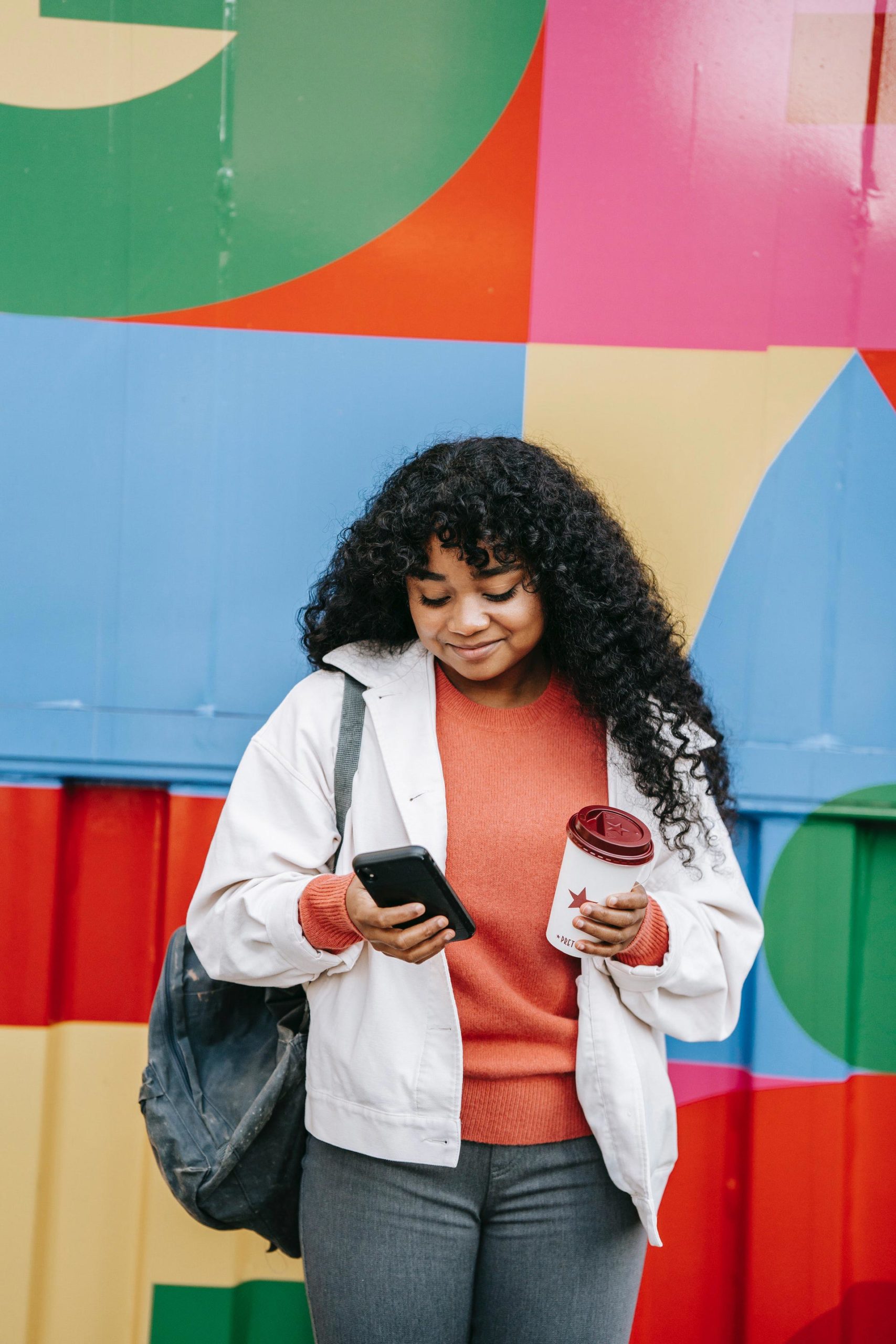smiling woman looking at phone